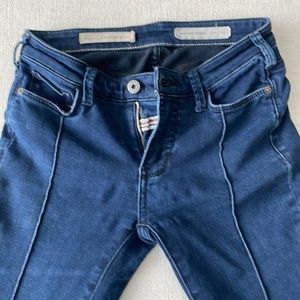 Anthropologie stretch skinny jeans size 25W with distressed bottom.